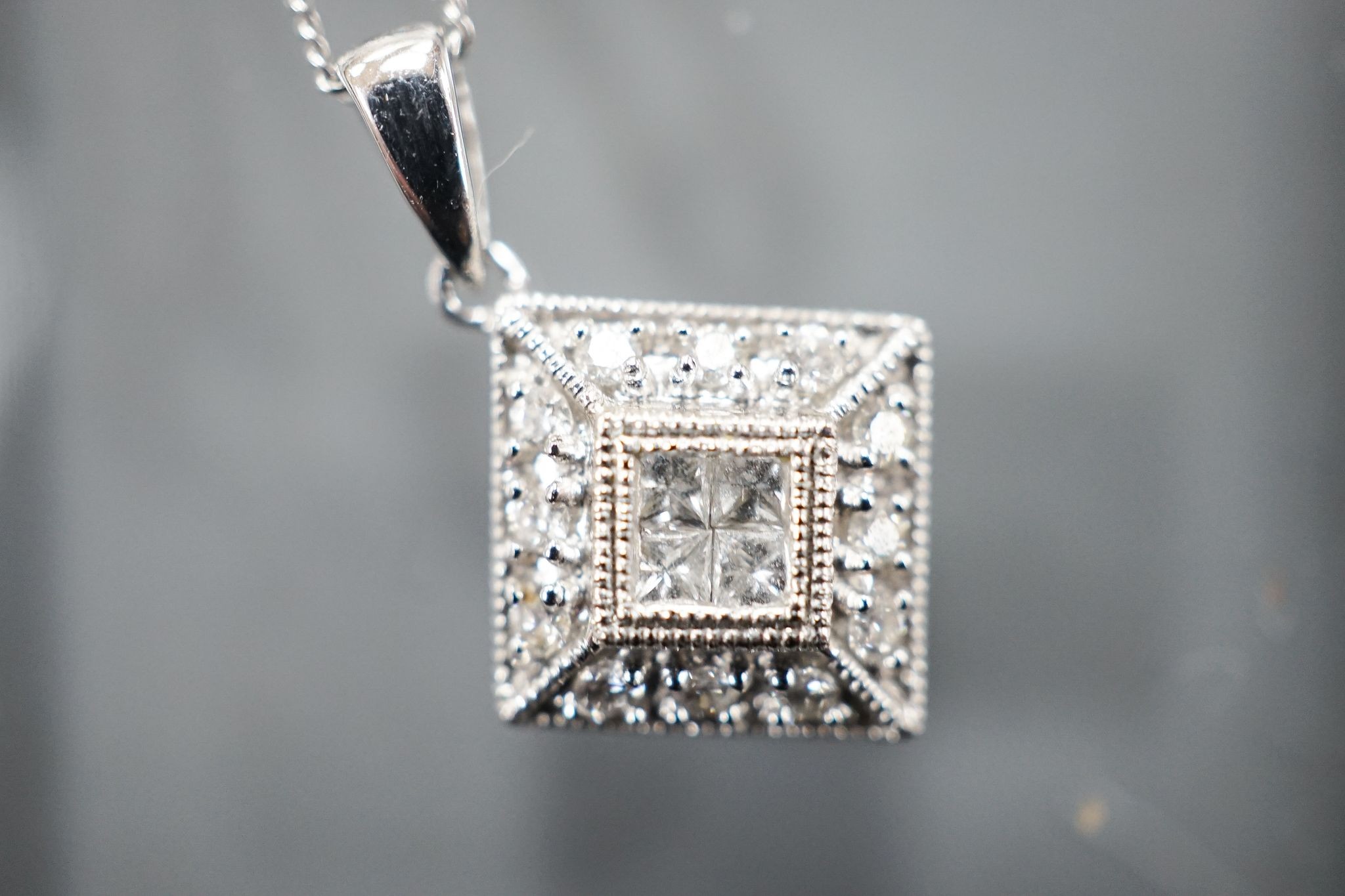 A modern 9k and diamond chip set pendant, 10mm, on a 585 fine link chain, 44cm, gross weight 2.1 grams.